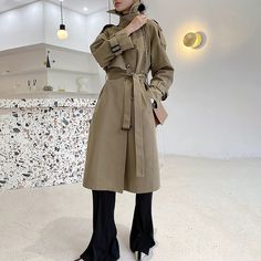 Look sharp and stay dry in this army green asymmetric trench coat! Featuring shoulder epaulets and a trendy belted waist, you'll be the chicest one around town even in the rainiest of days. Button up the gun flap for extra coverage, and voilà – you're ready for a stylish adventure! Long sleeves Spread collar with button belt Button gun flap Belted cuffs Front welt pockets Removable tie belt Lined Cotton, polyester Machine wash, tumble dry Item #310265 SIZE INFO XS=US2=UK6=EU32 S=US4-6=UK8-10=EU3 Khaki Belted Long Coat, Trendy Belted Outerwear For Winter, Khaki Belted Double-breasted Outerwear, Spring Outerwear With Belt, Double-breasted Belted Fall Outerwear, Fall Double-breasted Belted Outerwear, Fall Double-breasted Outerwear With Belt, Women Raincoat, Spring Trench