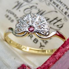 a close up of a ring on top of a piece of paper with writing in the background