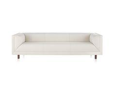 a white couch sitting on top of a wooden frame