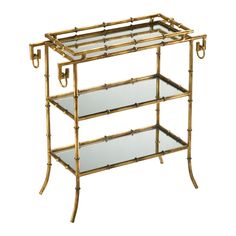 a gold bamboo shelf with glass shelves