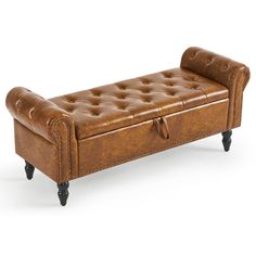 a brown leather bench sitting on top of a white floor