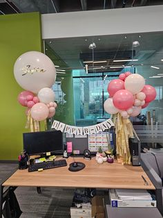 an office decorated with balloons and streamers