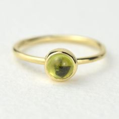 A stunning green peridot stacking ring made from solid 9ct yellow gold. Choose to wear the ring on its own, or mix and match it with other stacking rings from the Nebula collection, or why not add a sparkling Andromeda diamond ring?Peridot is a beautiful juicy green gemstone and the birthstone of August. It is one of only a few stones to come in only one colour, a lovely olive green and is said to bring a wonderful year to whoever wears it. It's warm glowing colour is a reminder of summer and of Green Stackable Round Band Rings, Fine Jewelry Green Birthstone Stackable Rings, Green Birthstone Stackable Rings, Green Peridot Stackable Rings, Yellow Gold Stackable Rings With Peridot, Yellow Gold Peridot Stackable Rings For Anniversary, Green Peridot Stackable Promise Rings, Green Gemstone Stackable Rings With Round Band, Green Gemstone Stackable Round Band Rings