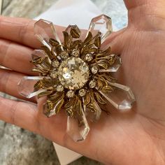 In excellent condition, a rare find. Huge glass & rhinestone signed Miriam Haskell brooch from the 1950's. Brass filigree setting in the shape of flowers with stems & leaves. A huge round rhinestone in the center prong set, measuring 3/4". Large & smaller clear cut glass petals that move freely. The large brooch measures 3". Amazing brooch. FREE SHIPPING in US Vintage Rhinestone Brooches For Evening, Vintage Evening Brooches With Rhinestones, Vintage Jeweled Crystal Brooches, Vintage Crystal Jeweled Brooches, Vintage Crystal Brooches For Formal Occasions, Vintage Crystal Brooches For Anniversary, Gold Crystal Brooch For Evening, Mid-century Brooch Jewelry For Party, Mid-century Party Brooch Jewelry