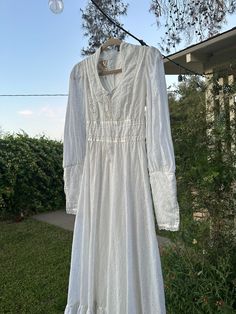 the perfect 1970s Gunne Sax by Jessica dress with eyelet fabric. features a deep open neckline, high collar, and lace-up bodice and a fitted zipper sleeve to give an exaggerated shape when on the body. Please note measurements. Bust 34'  Waist is 28' Hips free. shoulder 5.5  Sleeve 28 Length is 57 in incredible vintage condition with  stains and one small tear on back of hem- very easy to fix with tailor Fitted Long Sleeve Victorian Retro Dress, Elegant Fitted Prairie Dress With Smocked Bodice, Fitted Long Sleeve Regency Vintage Dress, Fitted Regency Style Vintage Dress With Long Sleeves, Regency Style Vintage Long Sleeve Fitted Dress, Fitted Vintage Dress With Lace Trim For Fall, Fall Vintage Fitted Dress With Lace Trim, Regency Style Long Sleeve Fitted Vintage Dress, Fitted Long Sleeve Vintage Dress In Cottagecore Style