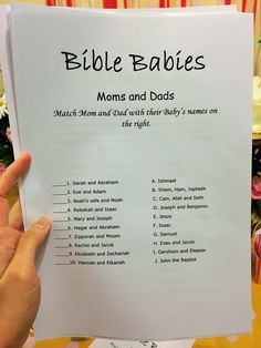 a person holding up a book with baby's names on it and the words bible babies