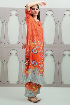 Orange asymmetric kurta with floral garden patterns and placement sequin embroidery. Comes with pant.
Components: 2
Pattern: Embroidered
Type Of Work: Floral, Sequin
Neckline: Round
Sleeve Type: Three quarter
Fabric: Crepe
Color: Orange
Other Details: 
Pintucked placket
Model Height: 5ft 10inches wearing size S
Weight: 800 grms
Occasion: Sangeet,Mehendi and Haldi - Aza Fashions Summer Straight Kurta Pant Set With Printed Motifs, Summer Pant Set With Printed Straight Kurta, Unstitched Bohemian Summer Sets, Elegant Summer Sets With Printed Motifs, Spring Pant Set With Straight Kurta And Printed Motifs, Spring Pant Set With Printed Motifs And Straight Kurta, Elegant Summer Palazzo Set With Printed Motifs, Unstitched Floral Print Sets For Summer, Bohemian Digital Print Summer Sets