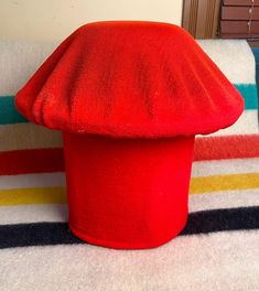 a red hat sitting on top of a white rug