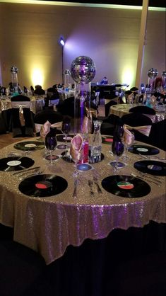 the table is set up for a party with disco ball decorations