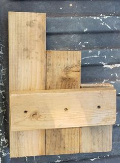 some wood is stacked on top of each other in order to be used as a wall decoration