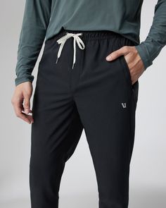 Train indoors, explore outdoors or travel to far-off destinations—no matter where you're headed, the Train Tech Pant is well-equipped. We designed these versatile bottoms with our performance 4-way stretch woven from mostly recycled materials, using their enhanced durability and moisture-wicking abilities to keep you performing, all day long. | Vuori Train Tech Pants | Black | XS Vuori makes premium performance apparel inspired by the active Coastal California lifestyle; an integration of fitnes Moisture-wicking 4-way Stretch Recycled Polyester Pants, Recycled Polyester Moisture-wicking Stretch Pants, Sporty Bottoms With Functional Pockets In Recycled Polyester, Sporty Bottoms With Functional Pockets And Recycled Polyester, Versatile Black Go-dry Pants, Versatile Black Activewear With Functional Drawstring, Athleisure 4-way Stretch Recycled Polyester Pants, Functional Black Sweatpants With 4-way Stretch, Athleisure Pants With 4-way Stretch In Recycled Polyester