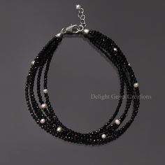 Product Details :  ITEM : BLACK SPINEL BEADED BRACELET Item Code : DGC4641 Gemstone Name :  BLACK SPINEL No. of Strand : 5 STRAND BRACELET Chain Style : BEADED Beads Shape : MICRO FACETED ROUND Beads Size : 2 mm Approx. Length : 8 INCH INCLUDING THE LOBSTER CLASP Weight : 30 Cts. Approx. Customization : **Available** Please Feel Free To Contact If You Have Any Query. Elegant Luxury Black Spinel Jewelry, Luxury Black Single Strand Jewelry, Elegant Multi-strand Polished Beaded Bracelets, Elegant Handmade Black Beaded Bracelets, Adjustable Black Bracelet With Faceted Beads, Adjustable Black Bracelets With Faceted Beads, Elegant Multi-strand Gemstone Beaded Bracelets, Black Gemstone Beads Bracelets For Jewelry Making, Adjustable Black Pearl Bracelet