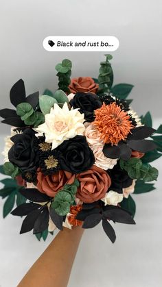 a bridal bouquet with black and rust flowers