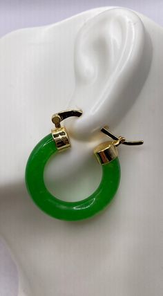 "These are lovely Green Jade Hoop Earrings  Approximately 1 inch See our full collection of Vintage Jade: https://www.etsy.com/shop/EastVillageBangles?section_id=38654118 Jade, a birthstone of August, is often the gemstone associated with the twelfth wedding anniversary.  Jade comes in Nephrite and Jadeite varieties, each a crystallized form of silica. Jade draws its name from the Latin ilia, meaning 'flanks, kidney area' giving rise to the informal \"loinstone\".  Jade is known as a symbol of good luck, longevity, and wisdom promoting self acceptance and love. Jade brings a restoring energy balancing Heart chakra.   Jade is a relatively hard stone rating 6.5 on the Mohs scale.  Jade can be cleaned with mild soap in warm water, and a soft toothbrush or cloth.  Avoid harsh cleansers, bleach Cheap Handmade Jade Earrings, Affordable Jade Bead Earrings, Green Dangle Hoop Earrings For Anniversary, Elegant Green Small Hoop Huggie Earrings, Elegant Green Hoop Huggie Earrings, Modern Hinged Earrings As Gifts, Modern Hinged Earrings For Gift, Modern Green Round Hoop Earrings, Elegant Small Hoop Green Earrings