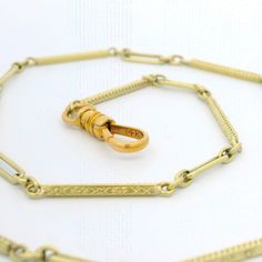 Material: 12k-14k Yellow Gold Weight: 8.09 Grams Chain Type: 13.75" - Elongated link - Spring Ring Clasp Thickness: 2.58mm (approx.) Condition: Overall finish & patina preserved. Excellent physical condition. Stock Number: JO-09039231-04202411-PAR Formal Engraved Link Necklaces, Formal Engraved Link Necklace, Formal Engraved Jewelry With Rectangular Links, Engraved Chain Link Necklace For Formal Occasions, Formal Engraved Chain Link Necklace, Engraved Yellow Gold Chain Link Jewelry, Engraved Yellow Gold Chain Link Necklace, Formal Etched Yellow Gold Necklace, Formal Yellow Gold Etched Necklace