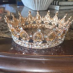 a gold tiara sitting on top of a wooden table