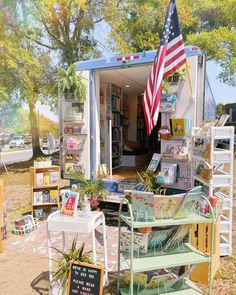 a small book store with an american flag on the door and shelves full of books