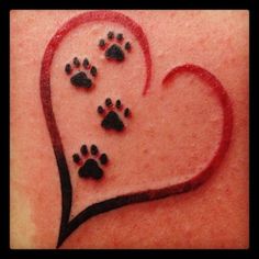 a heart shaped frame with paw prints on it