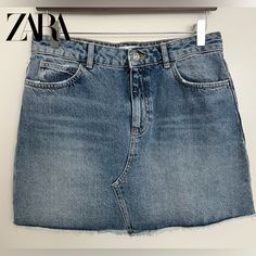 Zara Denim Mini Skirt. Medium (28) Blue. Pre Owned (Never Used) Please Reference Pictures For Measurements And Condition, Small Stain Pointed Out In The Pictures. Blue Jeans Mini Skirt With Frayed Hem, Blue Mini Skirt Jeans With Frayed Hem, Zara Summer Denim Skirt With Pockets, Blue Zara Denim Skirt For Spring, Zara Denim Skirt With Pockets For Summer, Zara Blue Denim Skirt For Spring, Zara Denim Skirt Medium Wash With Pockets, Zara High Rise Blue Skirt, Zara Medium Wash Denim Skirt With Pockets