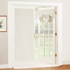 an open door with white curtains on it