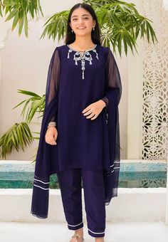 3- Piece Embroidered Suit for Girls Description : Top: Navy Blue Chiffon Kurta with Hand Adda Work and Malai Crepe Lining Bottom: Navy Blue Raw Silk Trouser Dupatta: Navy Blue Chiffon Dupatta with Laces Country of Origin : Pakistan General Care Instruction : Should be washed in gentle cycle and hung to dry. Color may bleed so please be mindful of other items with it. General Disclaimer: Size chart provides reference sizes and actual sizes might be slightly different from the size chart. Actual c Blue Chiffon Party Sets, Summer Party Georgette Salwar Kameez, Blue Fitted Chiffon Sets, Summer Formal Georgette Sets, Long Sleeve Georgette Salwar Kameez For Summer, Unstitched Chiffon Sets For Summer, Blue Chiffon Salwar Kameez For Eid, Embroidered Chiffon Sets With Long Sleeves, Party Chiffon Sets With Mirror Work