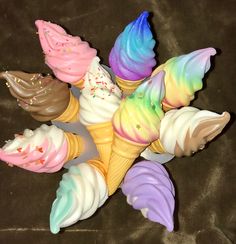 there are many ice cream cones with different colors on the top one has sprinkles