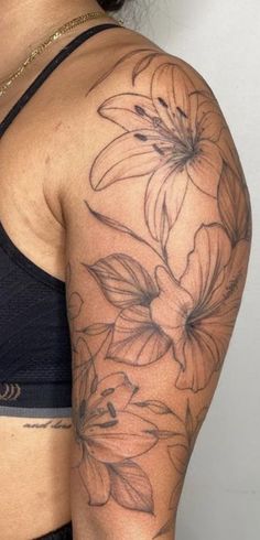 a woman's arm with flowers on it and the bottom half of her arm