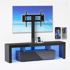 an entertainment center with a flat screen tv and remotes on the wall next to it