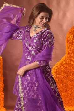 Purple banarasi silk kurta with floral pattern. Comes with sharara and a dupatta.
Components: 3
Type Of Work: Floral
Neckline: V Neck
Sleeve Type: Three quarter
Fabric: Banarasi silk
Color: Purple
Other Details: 
Note: Necklace worn by the model is not for sale.
Occasion: Mehendi and Haldi - Aza Fashions Traditional Anarkali Brocade Sharara, Festive Banarasi Silk Palazzo Set For Wedding, Wedding Brocade Palazzo Set With Zari Work, Purple Brocade Bollywood Sets, Purple Bollywood Brocade Sets, Festive Brocade Sharara With Zari Work, Anarkali Palazzo Set In Banarasi Silk For Wedding, Bollywood Brocade Floor-length Sharara, Bollywood Banarasi Silk Palazzo Set For Wedding