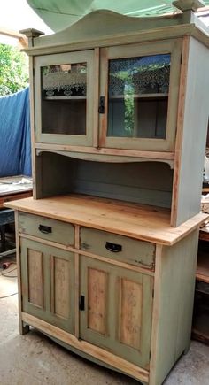 an old china cabinet with glass doors and drawers