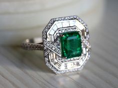 Natural Emerald Art Deco engagement ring, Antique engagement ring, 2.5 carat Emerald cut, Diamond baguette halo engagement ring This unique emerald ring comes with 2.5 carat Emerald and is surrounded by diamonds is made for special occasions! Same design can be made also with other custom gemstones per request. Product details: - 14k or 18k Solid gold - approx. 2.5 carats Genuine Great quality emerald with a certificate of authenticity. - approx. 1.22 carats genuine G VS-SI diamonds - Made to or Art Deco Gia Certified Emerald Ring As Gift, Gia Certified Art Deco Emerald Ring Gift, Art Deco Emerald Ring With Halo Setting For Anniversary, Art Deco Emerald Ring With Halo Setting, Gia Certified Art Deco Jewelry For Anniversary, Art Deco Gia Certified Jewelry For Anniversary, Art Deco Emerald Ring With Accent Stones For Anniversary, Antique Emerald Engagement Ring, Baguette Halo