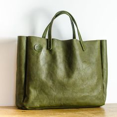 Olive Green Italian Leather Box Bag  Each bag is made from Full Grain, World Famous Badalassi Carlo Leather and is finished with hand stitched  handles in the same leather. This leather bag is the perfect size for use as an everyday carryall, as a stylish work bag or a weekend bag. Item Details: * Handmade in Manchester, England * Premium Quality Full Grain Badalassi Carlo Italian Leather  * Hand-stitched  Approx. external dimensions: Width: 40cm (15.75") Height: 33cm (13") Depth: 10cm (4") Bada Green Rectangular Briefcase, Green Textured Leather Tote Bag, Green Textured Leather Rectangular Bag, Green Leather Rectangular Satchel, Green Rectangular Leather Bag, Green Top Handle Briefcase For Everyday Use, Green Rectangular Leather-lined Bag, Leather Square Box Bag For Errands, Green Textured Leather Bag For Daily Use