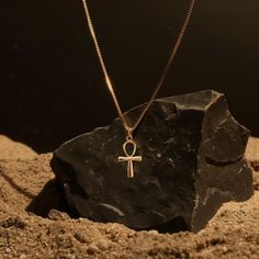 This solid gold key of Ankh necklace showcases exquisite craftsmanship, symbolizing life and spirituality. The key of Ankh pendant is more than just jewelry; it's a fine representation of ancient Egyptian elegance and the timeless allure of this sacred symbol. PENDANT INFORMATIONThis pendant is made of real, solid gold.• Made in USA• Size: MINI• Material: 14k or 18k solid gold• Finish: polished• Height: 1.12" (28 mm) x Width: 0.54" (16 mm)• Pendant weight (approx.): 3 grams (14k)• Bail: fits up to 4 mm chains• Solid back, not hollow• A certificate of authenticity is included• Delivered in our elegant jewelry box, making it the perfect giftPlease note: Our Mini sized pendants are small and delicate pieces - please verify the dimensions before placing your order.Shipping:All of our orders ar Symbolic Ankh Brass Necklace, Amulet Style Ankh Necklace In Brass, Spiritual Cross Pendant Necklace With Box Chain, Gold Ankh Amulet Jewelry, Gold Ankh Amulet Necklace, Symbolic Ankh Jewelry For Meditation, Spiritual Ankh Necklace In Yellow Gold, Yellow Gold Ankh Necklace, Spiritual Ankh Pendant Jewelry