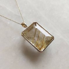 ITEM DESCRIPTION: >>The pendant is made from Solid 14K Yellow Gold. Gemstone used is absolutely natural and ethically sourced. >>Natural Golden Rutile in crafted bezel setting is studded on it with utmost precision. >>This is a minimalist design and is absolutely hassle-free and everyday jewelry. Gem: Golden Rutile Gem size: 18x23.5mm Gem weight: 35.00 carats Gold purity: 14K (58.33% approx.) Gold weight: 3.43 grams Gross weight: 10.43 grams The Gold purity is guaranteed and it comes with authen Gold Jewelry With Rectangular Polished Stone, Gold Jewelry With Polished Finish And Rectangular Stone, Fine Jewelry Rectangular Pendant With Diamond Cut, Fine Jewelry With Diamond Cut Rectangular Pendant, Fine Jewelry With Rectangular Diamond Cut Pendant, Fine Jewelry: Diamond Cut Rectangular Pendant, White Gold Gemstone Rectangular Pendant Jewelry, Gold Diamond Pendant Gemstone, Fine Jewelry Polished Rectangular Pendant Necklace