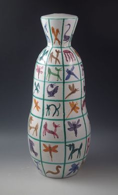 a white vase with colorful designs on it