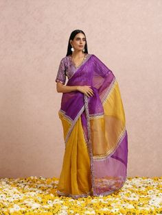 Featuring a golden yellow and plum colourblock silk organza saree with gota placements all over. It is paired with a plum blouse having gota and hand embroidery. Color: Golden Yellow & Plum Fabric: Sari - Organza Silk Blouse - Chanderi Note: The product will be shipped within 30-35 days of order placed Wash care - Dry Clean Only. Do not use heavy Iron Purple Organza Pre-draped Saree With Dupatta, Purple Saree With Gota Work In Traditional Drape, Purple Saree With Gota Work, Purple Gota Work Saree For Navratri, Purple Saree With Gota Work For Navratri, Purple Tissue Silk Pre-draped Saree With Sheer Dupatta, Purple Gota Work Saree For Diwali, Purple Organza Pre-draped Saree For Diwali, Purple Saree With Gota Work For Festive Occasions