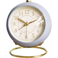 an alarm clock is shown on a white background with gold trim around the face and hands