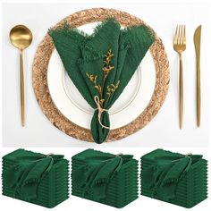 a place setting with green napkins and gold forks