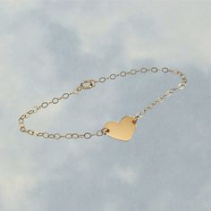 14k Solid Heart Bracelet * The perfect gift for a mom, wife, or anyone near and dear to your heart! Great for Valentine's Day, birthday, or anniversary presents! * Details * Heart Size: 1/2" x 3/8" Material: 14k Solid Gold Chain: 1.5mm Cable Chain Length: Your choice of Exact length 6"-8" or Adjustable Length * Please include the initial you would like in the personalization field or request "blank" * This is real 14k solid gold that is made to last! Our 1.5mm Cable chain is a lightweight yet sturdy chain that is perfect for pendants and charms like the one on this bracelet! A more heavyweight and sturdy chain option is the 2.5mm chain which is available upon request in the personalization field! Golden Drip 777 is a new Etsy shop offering some steep discounts (with more limited variations Minimalist Heart Bracelet For Anniversary, Classic Heart Charm Bracelet For Wedding, Classic Heart Cut Bracelet For Gift, Classic Wedding Heart Charm Bracelet, Minimalist 14k Gold Heart Bracelet For Valentine's Day, Minimalist 14k Gold Bracelet With Heart Charm, Classic Heart-shaped Bracelets For Valentine's Day, Classic Heart Bracelets For Valentine's Day, Minimalist Gold Bracelet With Heart Charm