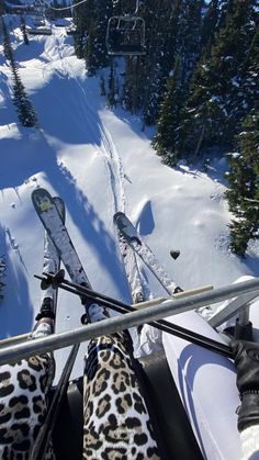 skiers are seen from the top of a ski lift in the snow on a sunny day