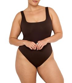 From Good American Plus&#x2C; this bodysuit features:Luxurious scuba compressive fabricationThong silhouette Square necklineWide strapsButton closureNylon/elastaneHand washImported. Black Leather Bodysuit, Leather Bodysuit, Scuba Knit, Tank Bodysuit, Modern Square, Faux Leather Pants, Good American, Dillard's, Black Bodysuit