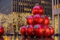 a large christmas tree made out of red balls