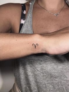 a woman's arm with a small tattoo on the left side of her arm