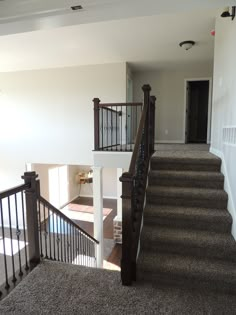 a staircase leading up to the second floor in a home with carpeted stairs and railings