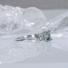 Echo is an asymmetrical, understated beauty. A striking contrast between the emerald cut Lab White Sapphire and a unique Moss Agate.   2mm wide ring shank 4mm x 6mm Moss Agate 3mm Lab White Sapphire   This ring can be custom made with alternative stones and different stone sizes - feel free to reach out if you would like to discuss a custom option. The ring will be made upon order, so please allow 1 to 3 weeks for the craftsmanship required. If custom made with alternative stones / stone sizes, Hair Sprays, Ring Shank, August Birthstone Jewelry, Body Lotions, July Birthstone Jewelry, Wide Ring, Corset Belt, Jewelry Ring Box, Pearl Jewellery Earrings