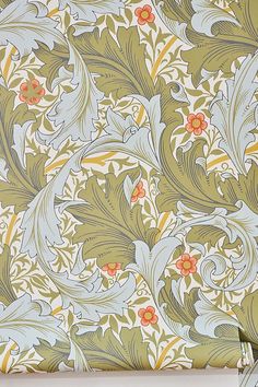 an ornate wallpaper design with flowers and leaves on green, blue, yellow and orange colors