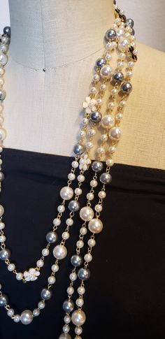 Description: Inspired to accessorize that black dress worn by Audrey Hepburn in Breakfast at Tiffany's, this beautiful extra long Vintage style Multi strand faux pearl necklace is sure to garner attention and turn heads! Really adds flare to that 'little Black Dress" This is a Chandra's Treasures original piece. I use beautiful lustrous imitation pearls for this piece with double sided black and white floral motifs containing a small faux pearl centerpiece. There are many ways to wear this neckl Luxury Double Strand Necklaces For Formal Occasions, Luxury Vintage Pearl Necklace With Embellishments, Cheap Statement Long Chain Necklace, Luxury Pearl Necklaces For Evening, Luxury Double Strand Necklace For Party, Affordable Statement Long Necklace For Party, Cheap Statement Long Necklace For Party, Luxury Formal Necklaces With Pearl Embellishments, Luxury Teardrop Statement Necklaces