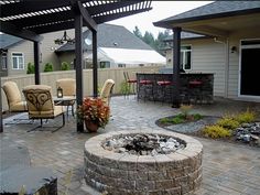 an outdoor patio with seating and fire pit