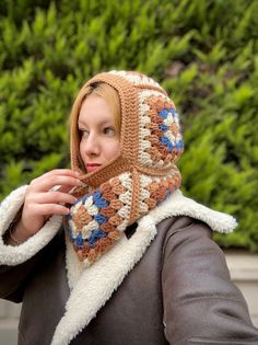 a woman wearing a crocheted hat and scarf