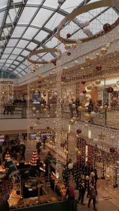 an indoor shopping mall filled with lots of christmas decorations